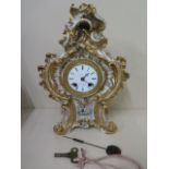 A porcelain clock with painting of flowers, 8 day movement silk suspension strikes on bell, Marc
