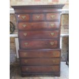 A Georgian oak chest on chest with an arrangement of three small drawers above six long drawers on