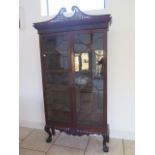 A 19th century mahogany astragal glazed two door bookcase on an associated carved base and swan neck