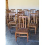 A set of eighteen 20th century dining chairs with leather seat pads, removed from a Cambridge