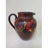 A large Moorcroft flambe fruit and flower decorated jug, 21cm tall, in good condition, some