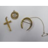 A gilt horseshoe brooch and a 9ct crucifix, 3cm long, hallmarked and a pendant horseshoe, pendant
