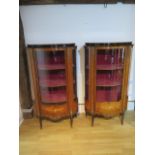 A pair of 20th century marquetry inlaid vitrine display cabinets with bow glass panels and ormolu