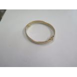 A 9ct tricolour gold bangle - 6cm x 6.5cm - external - marked 9kt - approx weight 13.8 grams - in