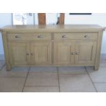 A good quality oak sideboard with two drawers and four cupboard doors, as new RRP £600, 200cm long x
