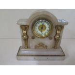 A small alabaster mantle clock by H.A.C, the case decorated with two gilded figures