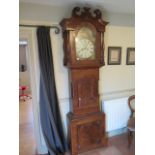 An 8 day mahogany striking longcase clock with a painted arched 14" dial signed R Heslop