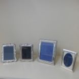 Four silver framed photograph frames - Largest 23cm x 18cm