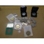 A collection of commemorative coins including two 10 dollar Concorde flight coins