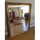 An ornate gilt modern mirror, 131cm x 102cm, small chip to gilt