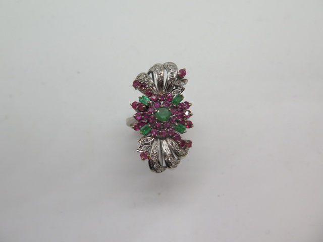 An impressive multi-gem white metal ring set with diamonds, rubies and emeralds, believed to be