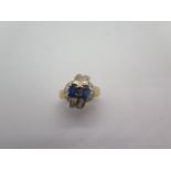 A hallmarked 18ct yellow gold sapphire and diamond crossover ring, size O, approx 7.6 grams, in good