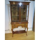 A good quality mahogany glazed display cabinet with two doors over a frieze drawer and two small