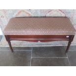 An Edwardian mahogany duet piano stool with an upholstered lift up top 48cm tall x 102cm wide x 41cm