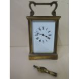 An 8 day brass carriage clock, with key, 11cm tall, working