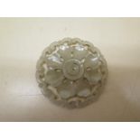 A carved jade roundel, 5.5cm diameter, in good condition