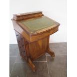 A Victorian inlaid walnut Davenport desk with four active side drawers and a correspondence top,