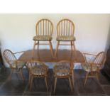A light Elm Ercol table and six chairs including two carvers, table 71cm tall x 151cm x 76cm, some