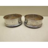 A pair of silver and wood coasters, 9.5cm diameter, London 1994, both generally good