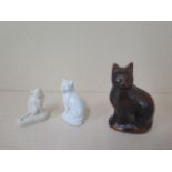 A Copeland parian ware model of a seated cat together with another and a 19th century pottery