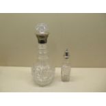 A cut glass decanter with silver collar - height 29cm - and a silver top glass shaker - both
