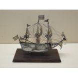 A Dutch silver model of a three mast sailing ship on a wooden base, 18cm tall x 19cm long,, total