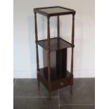 A Victorian style mahogany whatnot with a base drawer on brass caps and casters, 103cm tall x 33cm x