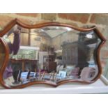 A mahogany shaped wall mirror, 44cm x 73cm