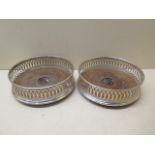 A pair of silver rim wine bottle coasters London 1986 JBld, 13cm diameter, in generally good