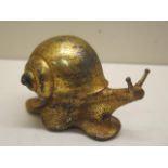 A gilt metal snail, 12cm long, with patinated finish