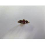 A 9ct yellow gold three stone garnet ring, size O, approx 2.6 grams, hallmarks worn but generally