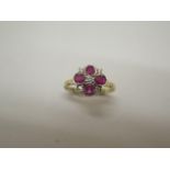 An 18ct hallmarked yellow gold ruby and diamond ring, size O, approx 2.5 grams, head approx 10mm