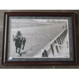 An Executive Sports Group signed horse racing photograph of jockey Ron Turcotte looking back,