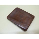 An early 1900s crocodile card case wallet with a fitted interior including stamp pockets, 13cm x