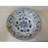 A Chinese 15th / 16th century blue and white dish decorated with a central peony surrounded by