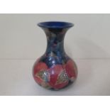 A William Moorcroft pomegranate and fruit decorated vase with green signature, 20cm tall, in good