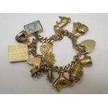 A 9ct charm bracelet with 13 charms, approx 58 grams, generally good and clasp working