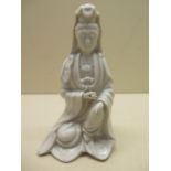 An 18th / 19th century blanc de chine model of Guanyin in seated pose, 18cm tall, minor damage to