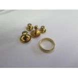 A hallmarked 18ct yellow gold band ring, size I/J and four 18ct shirt studs marked 18ct, total