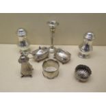 Six pieces of silver cruet, a serviette ring and a dented weighted vase, weighable silver approx 9.