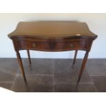 A modern mahogany two drawer sidetable with a foldover shaped top on turned legs, 79cm tall x 90cm