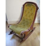 A late Victorian mahogany button back rocking chair in generally good condition
