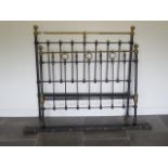A Victorian brass and iron 4'6" bed, headboard 55 inches tall, some wear to brasswork but a usable