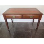A Victorian mahogany two drawer writing table with a leather inset, top on turned legs, 73cm tall