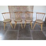 A set of four Ercol light elm seated kitchen chairs with cushions, 82cm tall all in useable