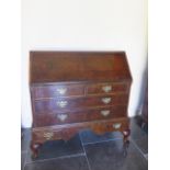 A 20th century Georgian style mahogany bureau with a fitted interior enclosed by a fall front
