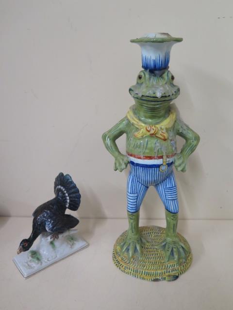 A faience type frog candle stick, 32cm tall, and a Dresden turkey, chips and repair to turkey,