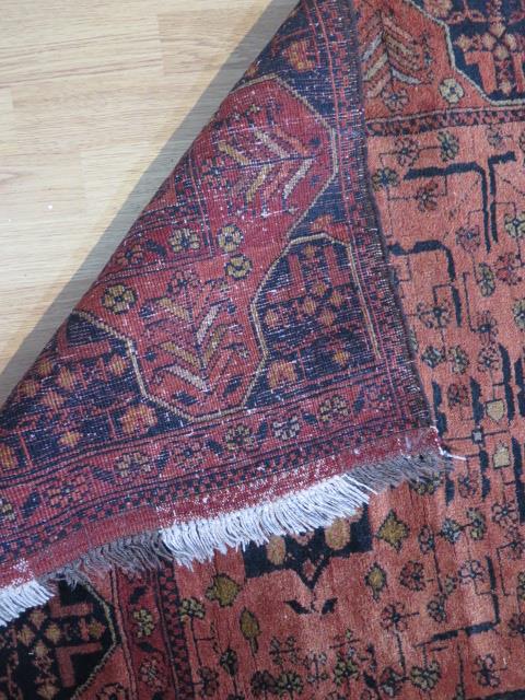 A hand knotted woollen rug, slight wear but generally good, 155cm x 104cm - Image 3 of 3