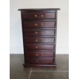A reproduction mahogany seven drawer collectors cabinet, 31cm x 30cm x 17cm, in polished condition