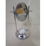 A silver manicure stand with mirror and weighted base, 16cm tall, no manicure pieces but generally